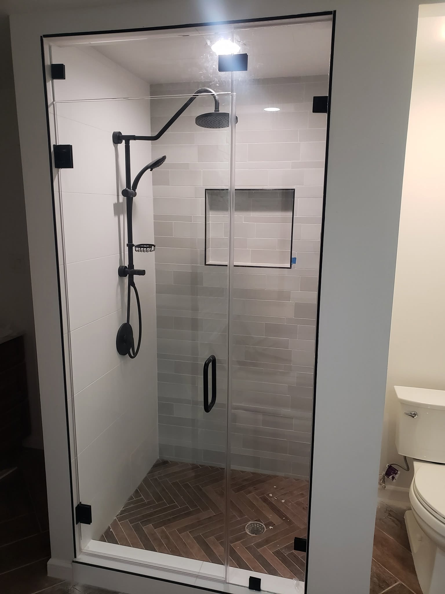 Tall inline shower door with matte black hardware
