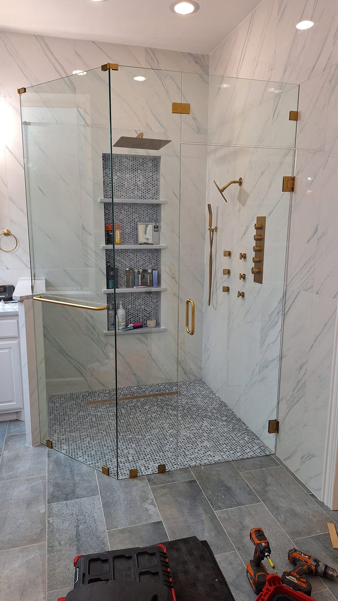 Clearwater frameless shower with brushed brass hardware